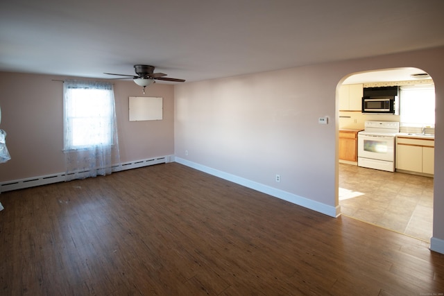 unfurnished room featuring ceiling fan, light hardwood / wood-style flooring, a baseboard radiator, and sink