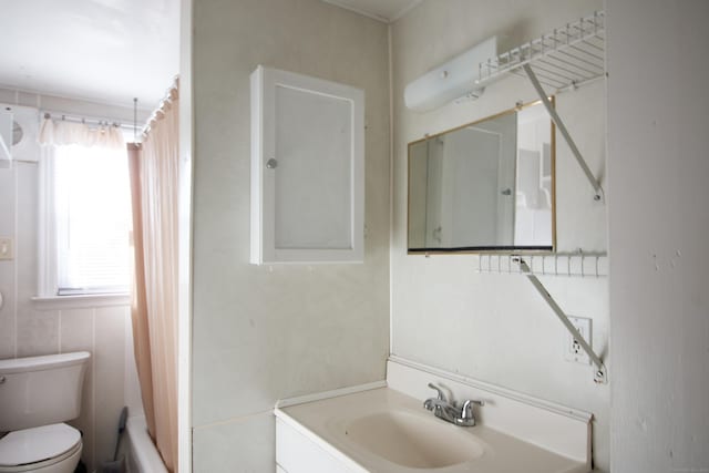 full bathroom with plenty of natural light, toilet, vanity, and shower / tub combo