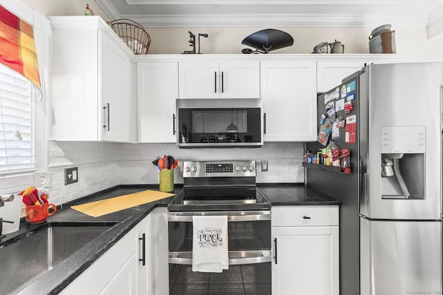 kitchen featuring white cabinets, sink, ornamental molding, and stainless steel appliances