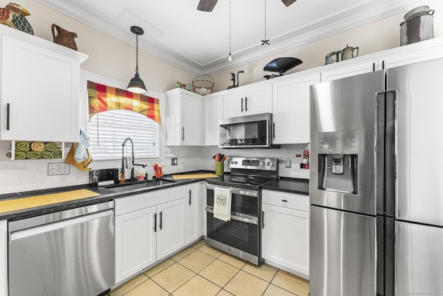 kitchen with white cabinetry, sink, decorative light fixtures, light tile patterned flooring, and appliances with stainless steel finishes