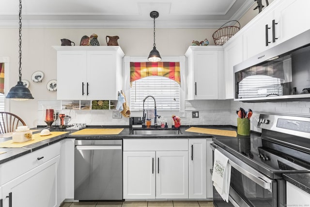 kitchen with white cabinetry, sink, hanging light fixtures, and appliances with stainless steel finishes