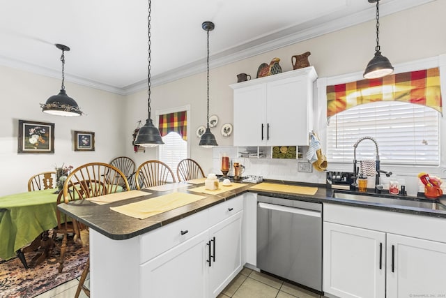 kitchen with white cabinets, light tile patterned floors, stainless steel dishwasher, and hanging light fixtures