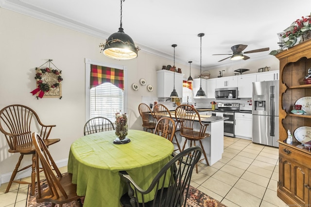 dining room with light tile patterned floors, ceiling fan, and crown molding