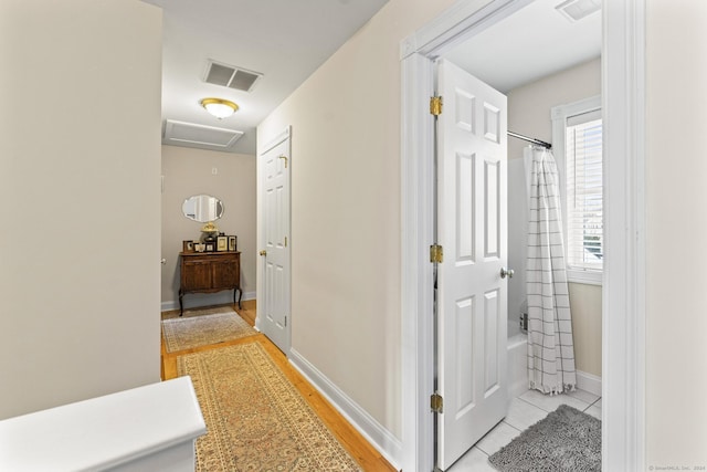 hallway with light tile patterned floors