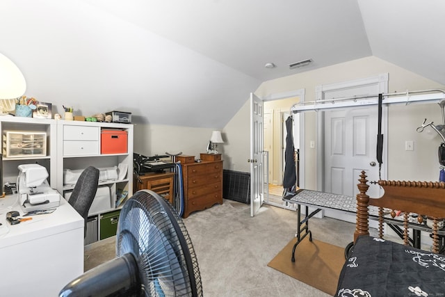 carpeted home office with lofted ceiling