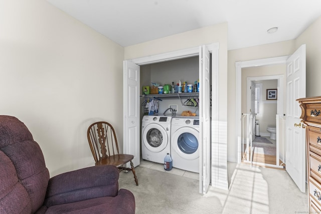 clothes washing area featuring washing machine and clothes dryer and light colored carpet