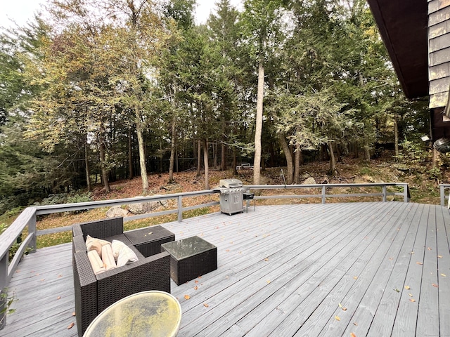 deck featuring outdoor lounge area and grilling area