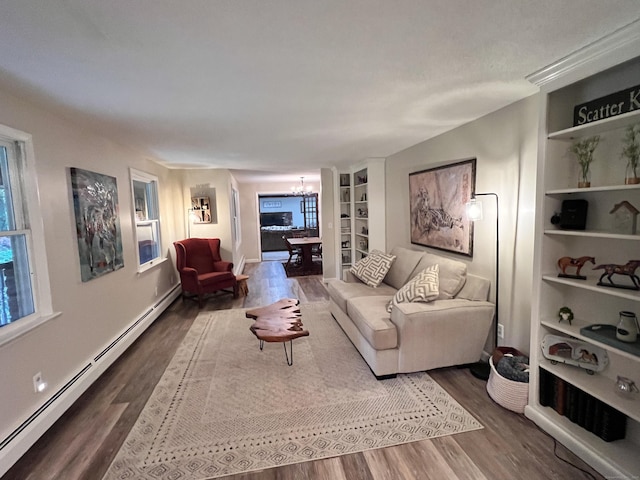 living room with dark hardwood / wood-style flooring, a baseboard radiator, built in features, and a notable chandelier