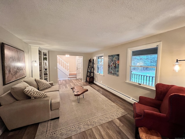 living room featuring hardwood / wood-style flooring, a textured ceiling, and a baseboard heating unit