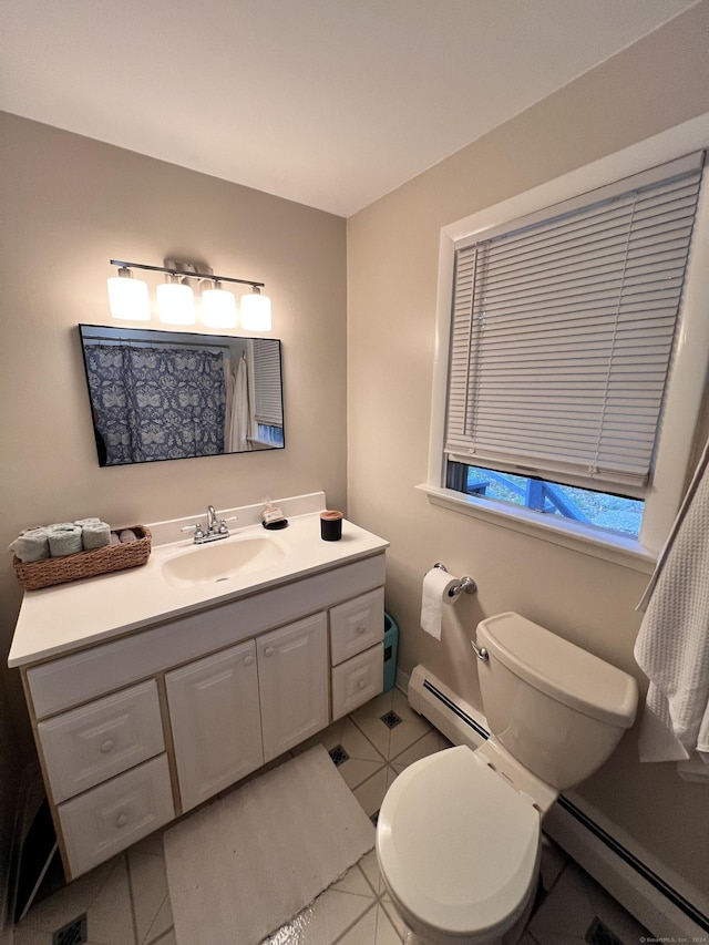 bathroom featuring toilet, vanity, tile patterned floors, and a baseboard heating unit