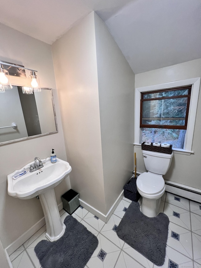 bathroom featuring baseboard heating, tile patterned flooring, and toilet