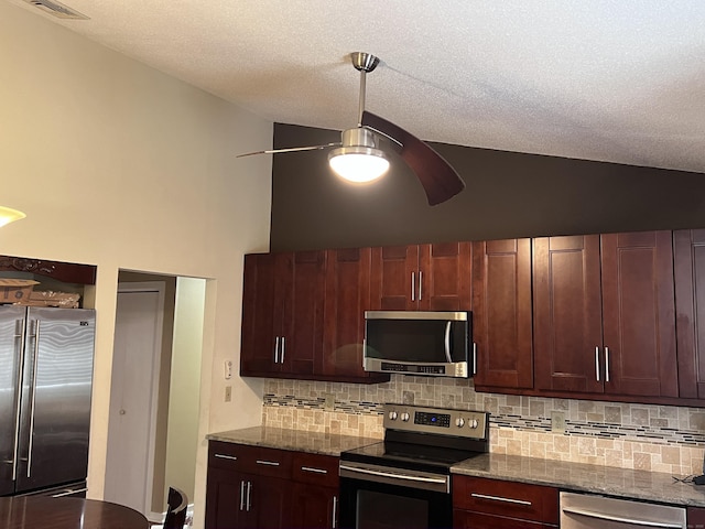 kitchen with tasteful backsplash, ceiling fan, vaulted ceiling, stainless steel appliances, and stone countertops