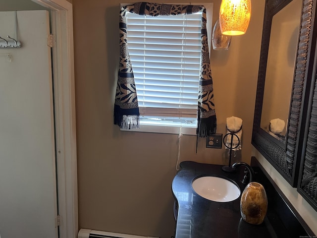 bathroom with a baseboard heating unit and sink