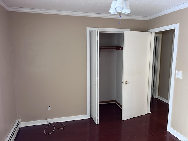 unfurnished bedroom with dark wood-type flooring, a baseboard radiator, a closet, and crown molding