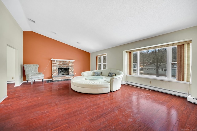 unfurnished living room featuring lofted ceiling, a fireplace, wood-type flooring, and baseboard heating