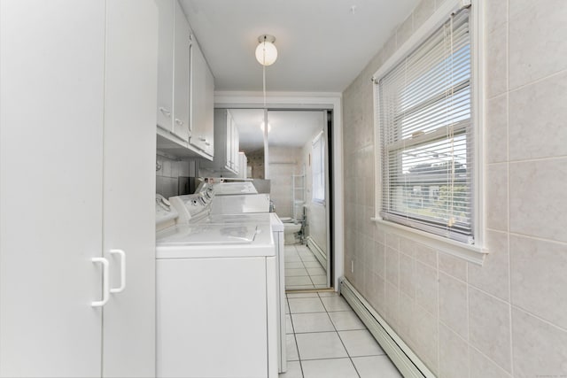 laundry room featuring cabinets, light tile patterned floors, washer and clothes dryer, and baseboard heating