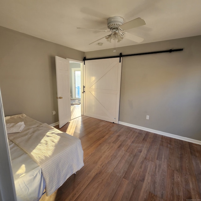 44 Washington Pkwy, Stratford, CT 06615 - bedroom featuring baseboards, a ceiling fan, wood finished floors, and a barn door