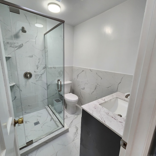 44 Washington Pkwy, Stratford, CT 06615 - bathroom with a marble finish shower, toilet, wainscoting, tile walls, and vanity