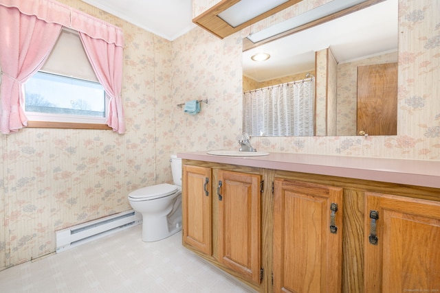 bathroom featuring crown molding, vanity, toilet, and a baseboard heating unit