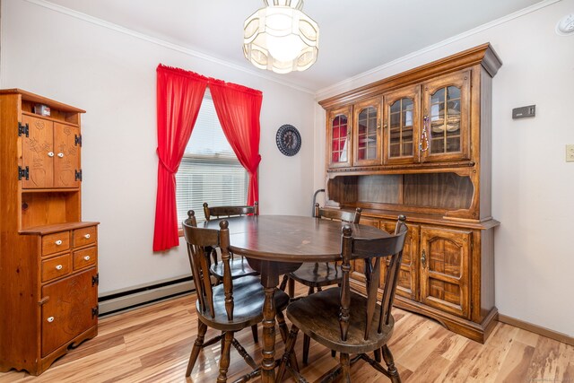 dining area featuring a baseboard radiator, ornamental molding, and light wood-type flooring