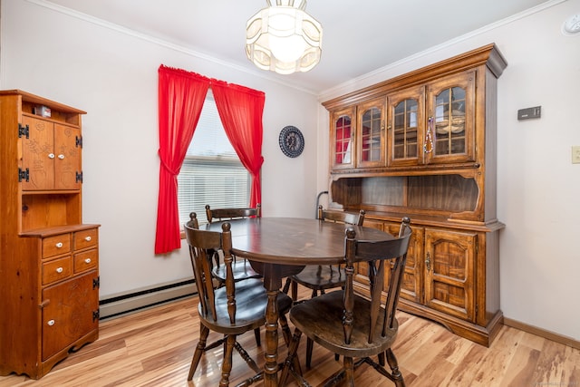 dining space with light hardwood / wood-style flooring, a baseboard radiator, and ornamental molding