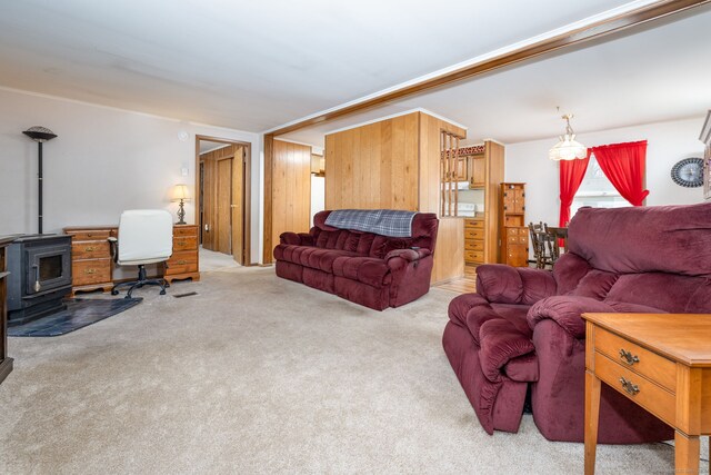 living room with a wood stove and light colored carpet