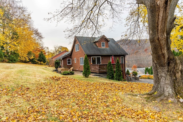 exterior space featuring a wooden deck and a yard