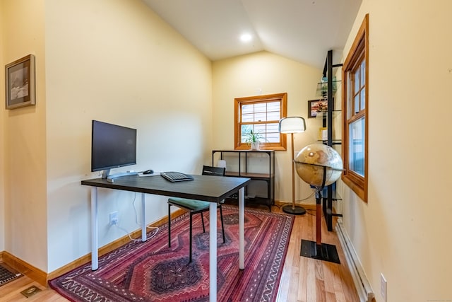 office featuring lofted ceiling and hardwood / wood-style floors