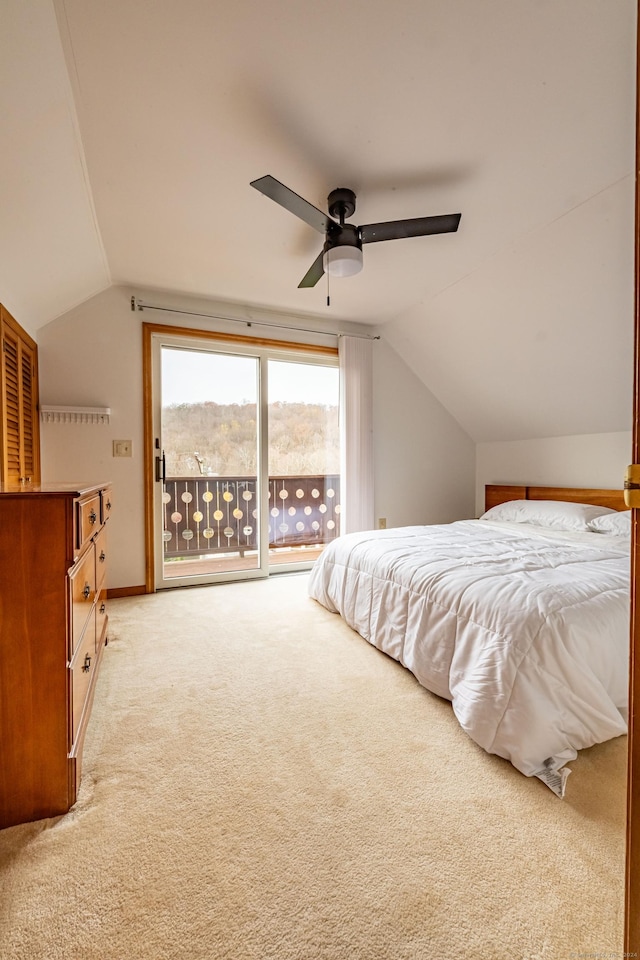 bedroom featuring light colored carpet, ceiling fan, access to exterior, and vaulted ceiling