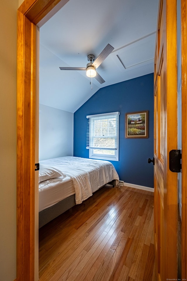 unfurnished bedroom with lofted ceiling, ceiling fan, and light hardwood / wood-style flooring