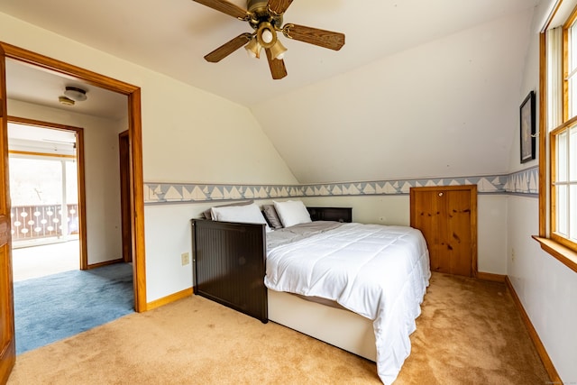 bedroom featuring vaulted ceiling, ceiling fan, and light colored carpet