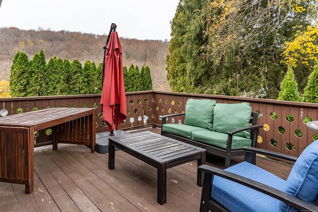 wooden terrace with an outdoor hangout area