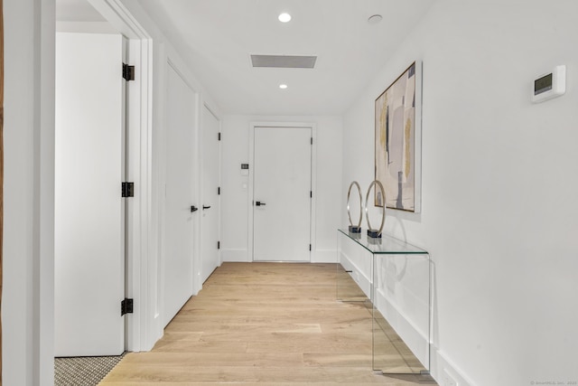 hall with light hardwood / wood-style floors