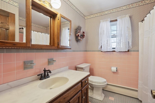 bathroom featuring a baseboard radiator, vanity, toilet, and tile patterned floors