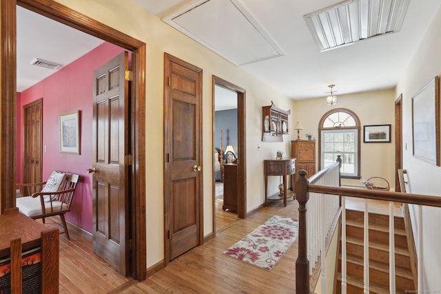 hallway with light hardwood / wood-style flooring