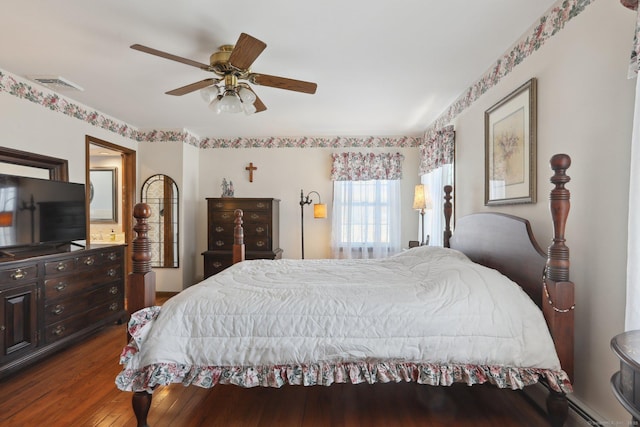 bedroom featuring ceiling fan, dark hardwood / wood-style flooring, and a baseboard radiator