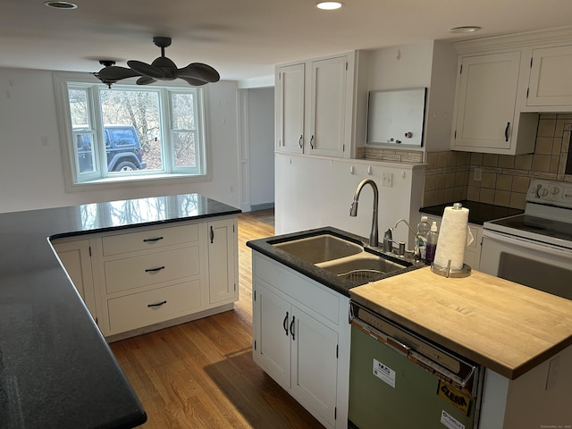 kitchen with white cabinets, a kitchen island with sink, sink, and dishwashing machine