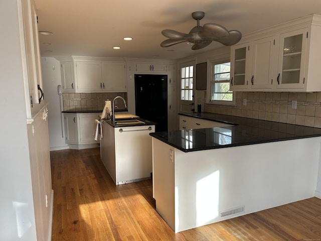 128 Main St S, Bridgewater, CT 06752 - kitchen featuring a peninsula, dark countertops, backsplash, white cabinets, and recessed lighting