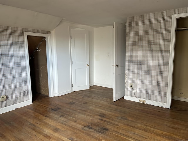 unfurnished bedroom featuring dark hardwood / wood-style flooring