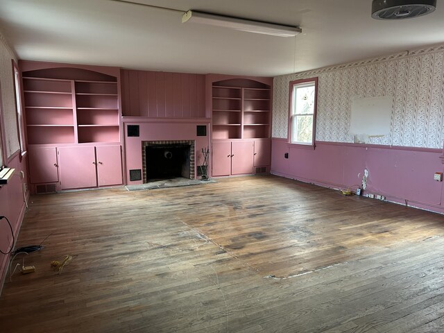 128 Main St S, Bridgewater, CT 06752 - unfurnished living room with a fireplace, hardwood / wood-style flooring, wallpapered walls, and built in features