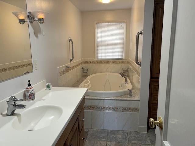 bathroom featuring vanity and a relaxing tiled tub