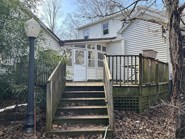 rear view of house featuring a sunroom