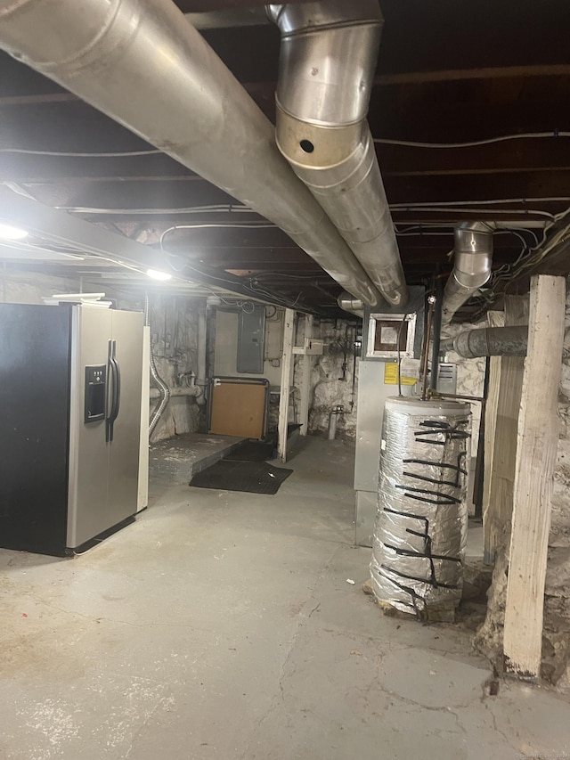 basement featuring stainless steel refrigerator with ice dispenser and electric panel