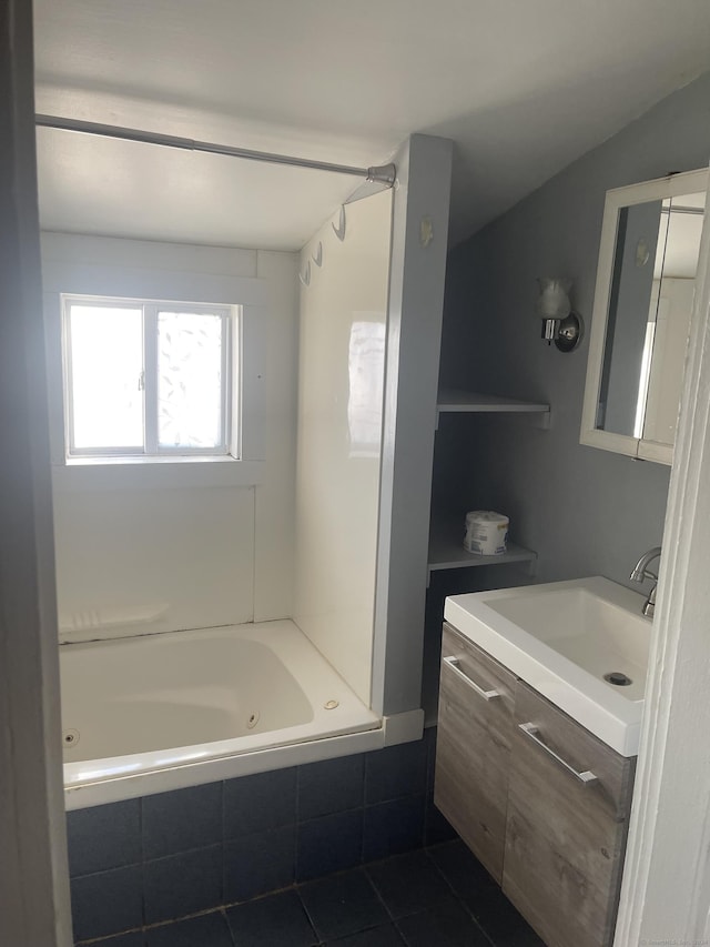 bathroom featuring tile patterned flooring, vanity, lofted ceiling, and tiled shower / bath combo