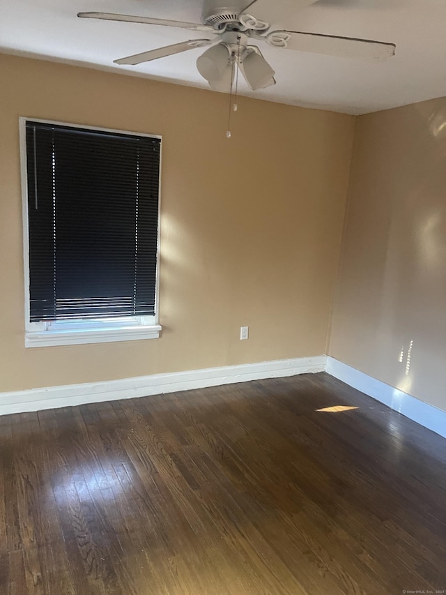 spare room with ceiling fan and dark hardwood / wood-style flooring