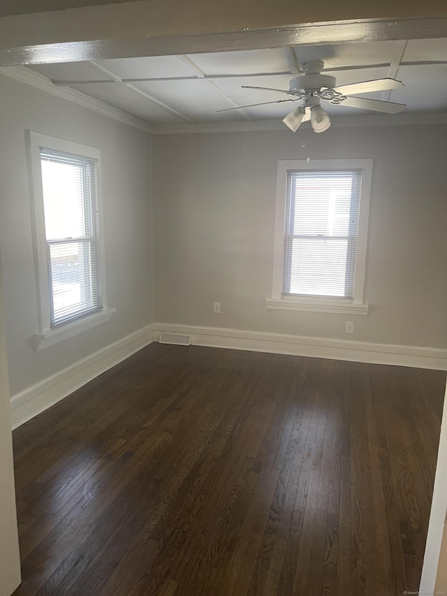 spare room with ceiling fan, dark hardwood / wood-style flooring, and crown molding