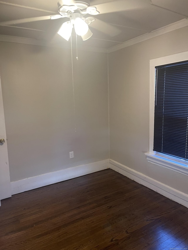 empty room with ceiling fan, dark hardwood / wood-style flooring, and crown molding