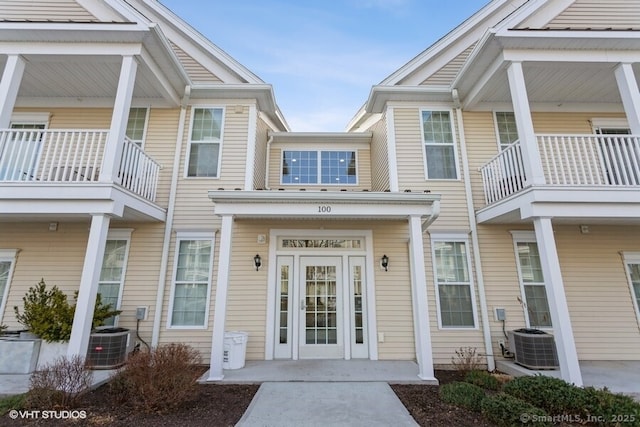 property entrance featuring a balcony and central AC unit