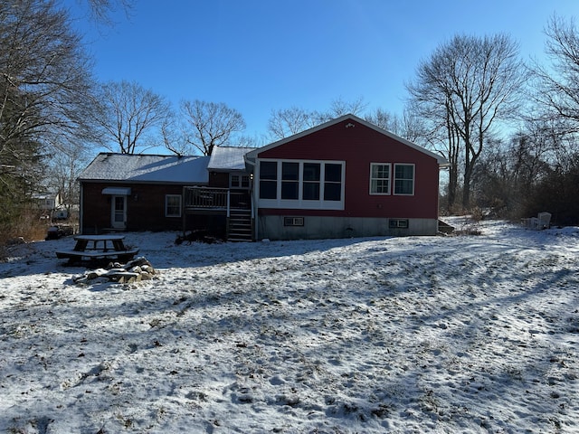 view of snow covered rear of property