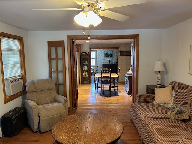 living room featuring hardwood / wood-style floors, ceiling fan, and cooling unit